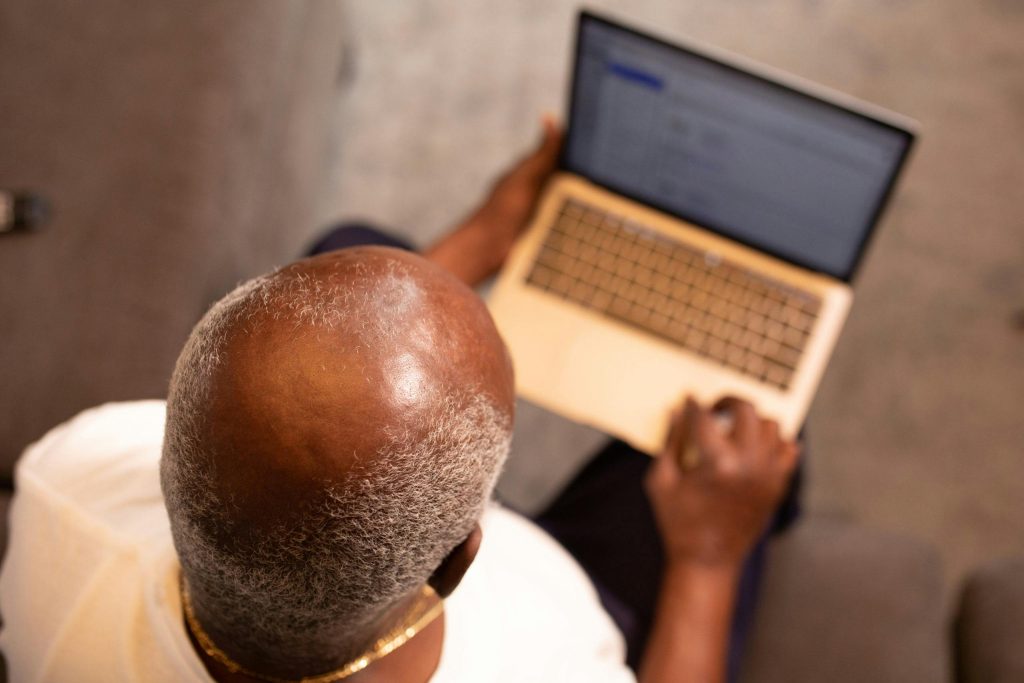 Man with thinning hair on computer