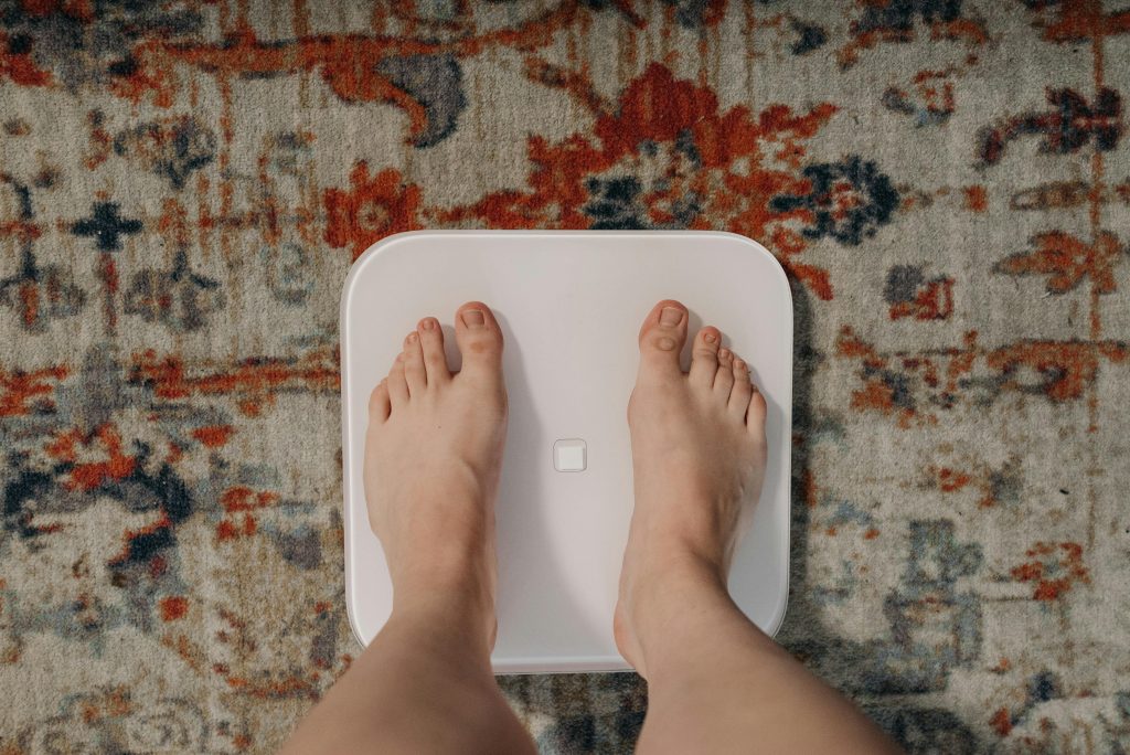 Person standing on a scale to measure weight loss