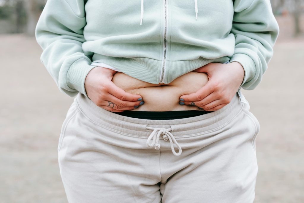 Woman holding her belly from perimenopause bloating